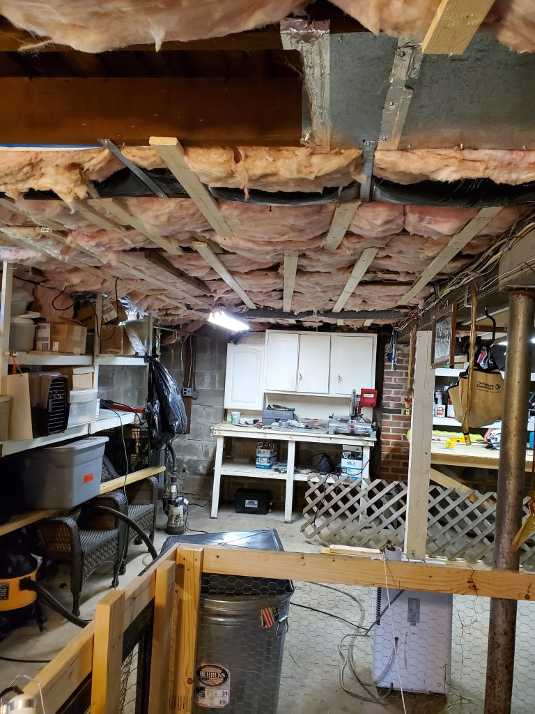 Basement with insulation in ceiling.